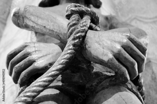 Quadro su tela Wooden statue of Jesus with tied hands. Black white photo.