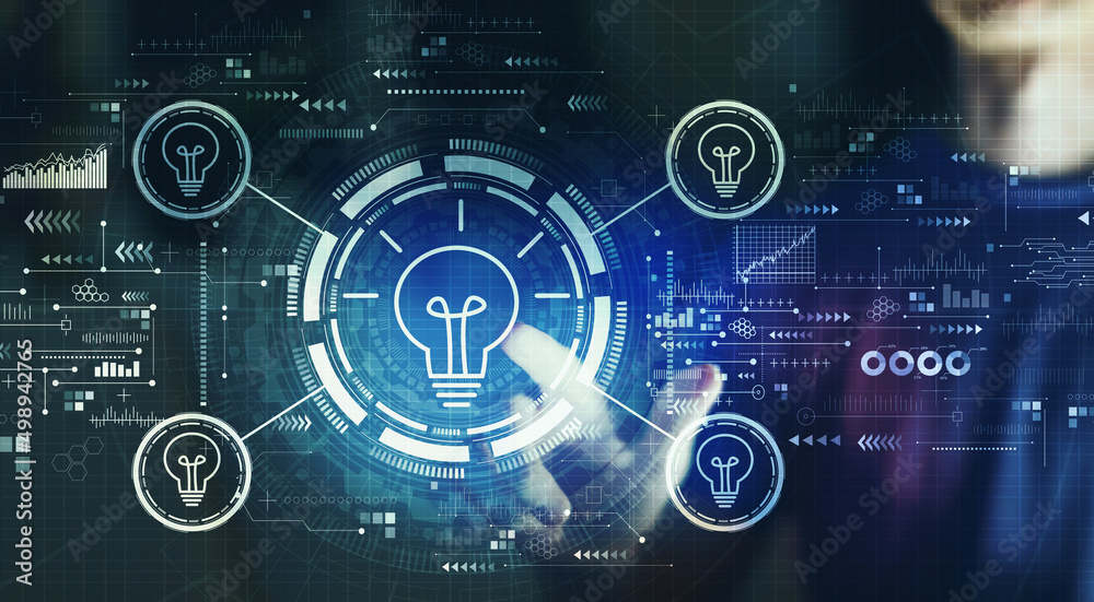 Idea light bulb theme with young man touching a digital screen at night Idea light bulb theme with young man touching a digital screen at night