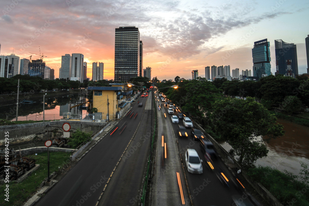 heavy traffic moving on the road in twilight, Jakarta