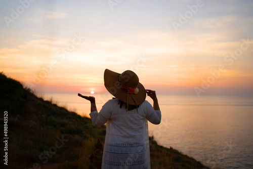  Traveler woman white dress  relaxing tropical beach mountain background.