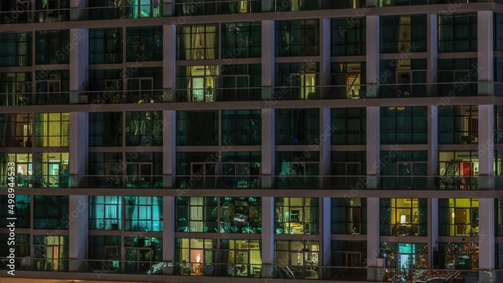 Big glowing windows in modern office and residential buildings timelapse at night Big glowing windows in modern office and residential buildings timelapse at night
