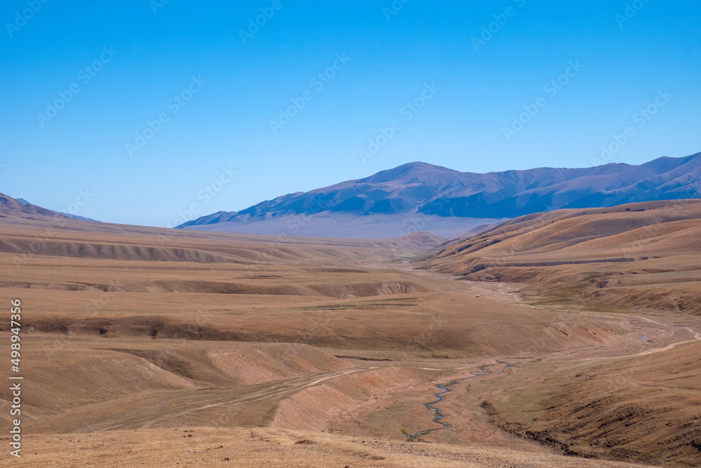 Beautiful mountain plateau with river in autumn season. Assy mountain river valley landscape. Travel tourism in Kazakhstan concept. Nature background. Outdoor landscape.