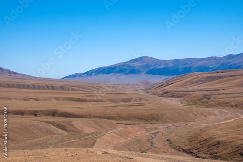 Beautiful mountain plateau with river in autumn season. Assy mountain river valley landscape. Travel tourism in Kazakhstan concept. Nature background. Outdoor landscape.