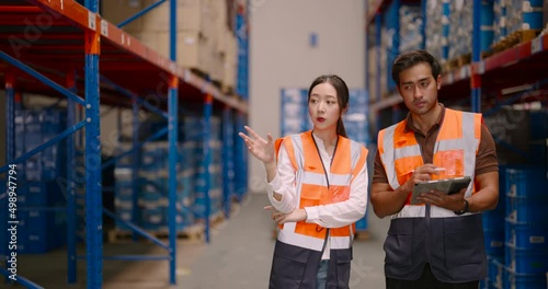 Warehouse workers discussing shipping schedule. Logistic and business export concept.