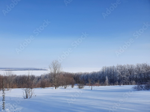 winter landscape. winter forest on the background of a frozen river © Наталья Удалова