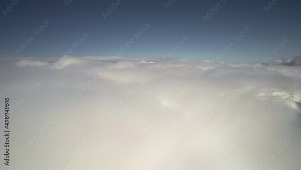 Flying through amazingly beautiful cloudscape. Picturesque timelapse of white fluffy clouds moving softly on the clear blue sky. Direct view from the cockpit. 4K UHD ProRes 422 Flying through amazingly beautiful cloudscape. Picturesque timelapse of white fluffy clouds moving softly on the clear blue sky. Direct view from the cockpit. 4K UHD ProRes 422