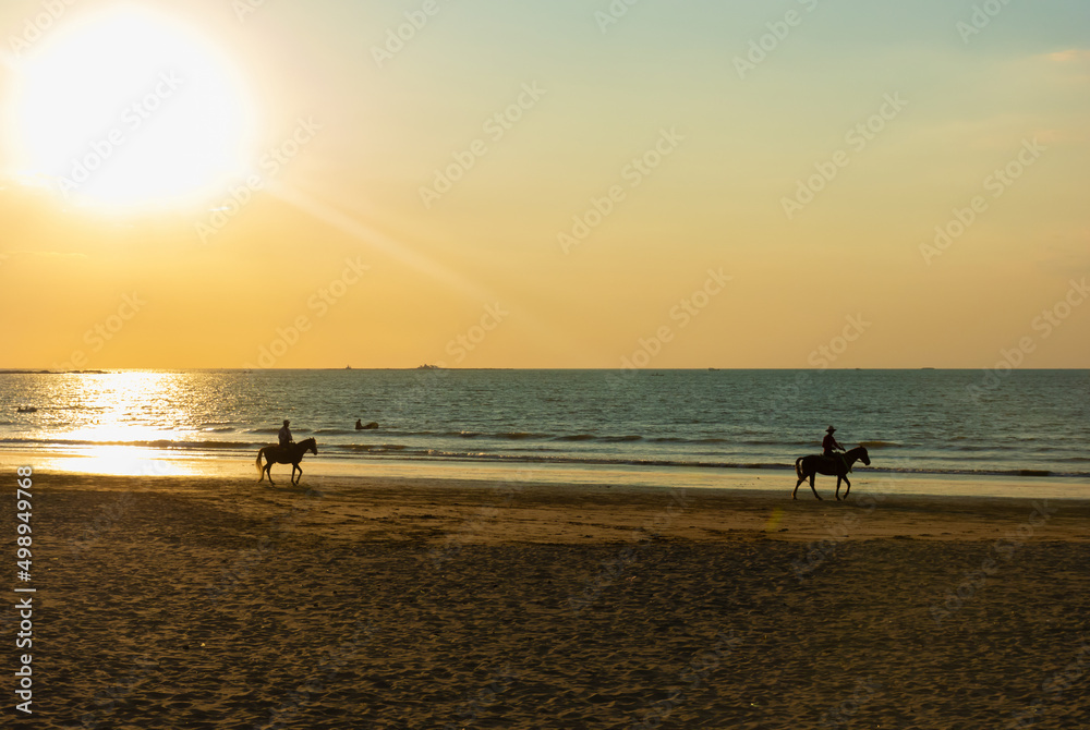 Riding horse on Chaung Thar beach during sunset