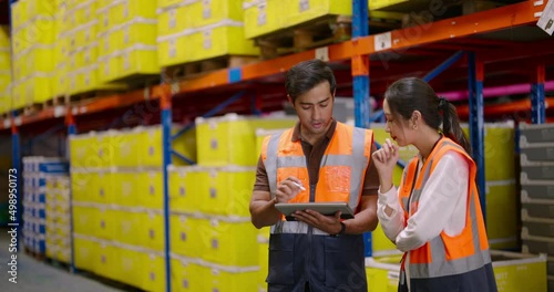 Warehouse workers discussing shipping schedule. Warehouse and Logistic business concept.