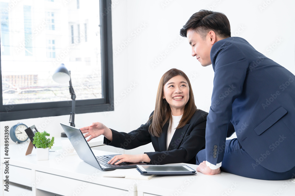 Asian young businesswoman wear formal suit working with colleagues man presenting new ideas on laptop with smiling face. Happy business people in workplace where they was accepted concept Asian young businesswoman wear formal suit working with colleagues man presenting new ideas on laptop with smiling face. Happy business people in workplace where they was accepted concept