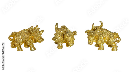 A golden two-headed bull metal statue is isolated on white background. A bull statue is an Asian protective amulet