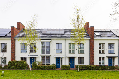 Row of modern newly build family houses along canal in Kortenoord in Wageningen, Gelderland in The Netherlands photo
