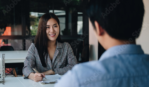 Employer or recruiter reading a resume during about colloquy his profile of candidate, employer conducting a job interview, manager resource employment and recruitment concept.