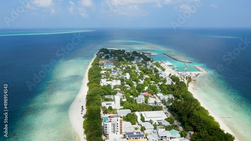 Tropical island in Maldives with white sand beach and turquoise sea water. Touristic vacation holidays travel destination. Scenic landscape. Drone aerial video footage. Ukulhas, North Ari Atoll.