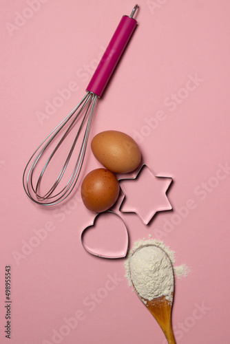 Baking ingredients on a pink background. Molds for making shortbread cookies.