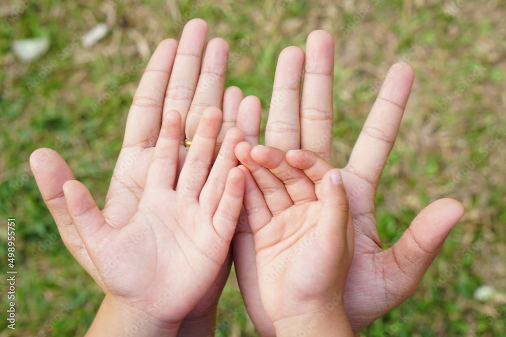 Mother and Child’s holding hands to receive something Mother and Child’s holding hands to receive something