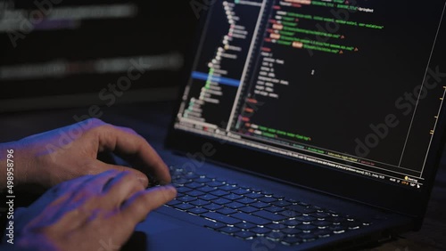 Programmer's hands and laptop keyboard close-up. Working on a project on a laptop. photo