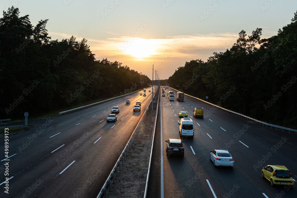 Traffic on highway at sunset