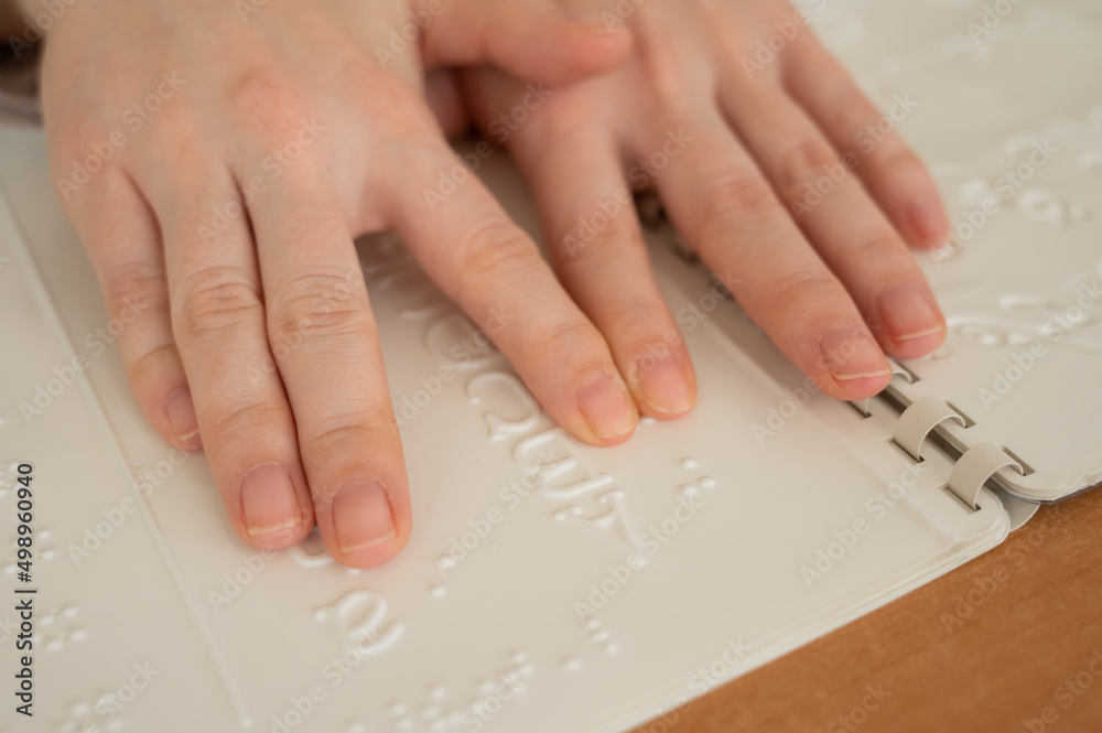 A woman learns the Braille alphabet using a decoder. A woman learns the Braille alphabet using a decoder.