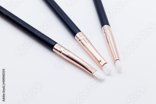 three pieces of makeup brushes on white background