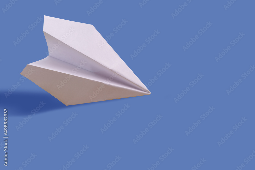 Paper airplane on a blue paper background Paper airplane on a blue paper background