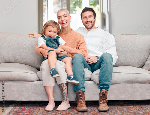 A day with a little boy. Portrait of a young family bonding while sitting on the sofa at home.