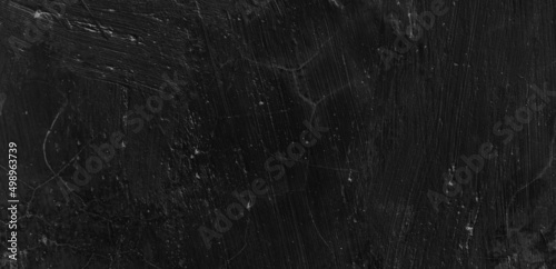 Dark scary black grunge textured concrete stone wall background. Old black wall texture cement