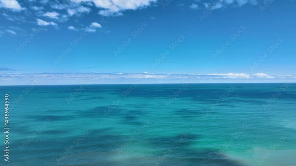 Fly over stunning azure Pacific Ocean towards endless horizon - New Zealand Fly over stunning azure Pacific Ocean towards endless horizon - New Zealand