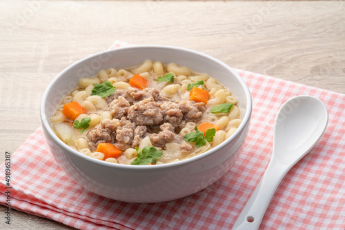 Macaroni Soup with minced pork ,carrots and onion ,easy asian style clear soup in white bowl