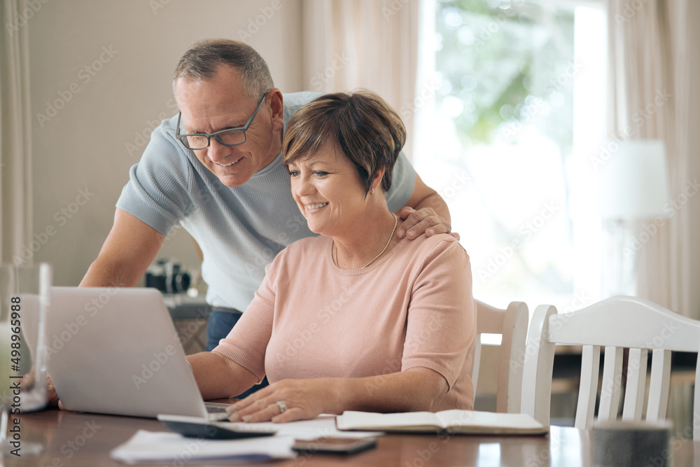 Im so proud of you honey. Shot of a mature husband and wife using a laptop together. Im so proud of you honey. Shot of a mature husband and wife using a laptop together.