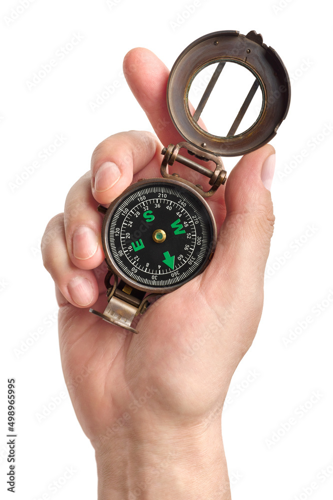 Hand holding traditional magnetic compass Hand holding traditional magnetic compass