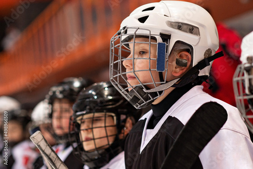 Little hockey player watching the game