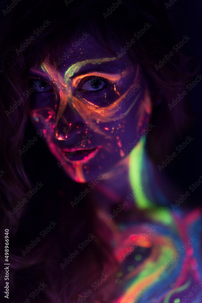 close-up of a woman with nuclear skin reacting to neon and black light