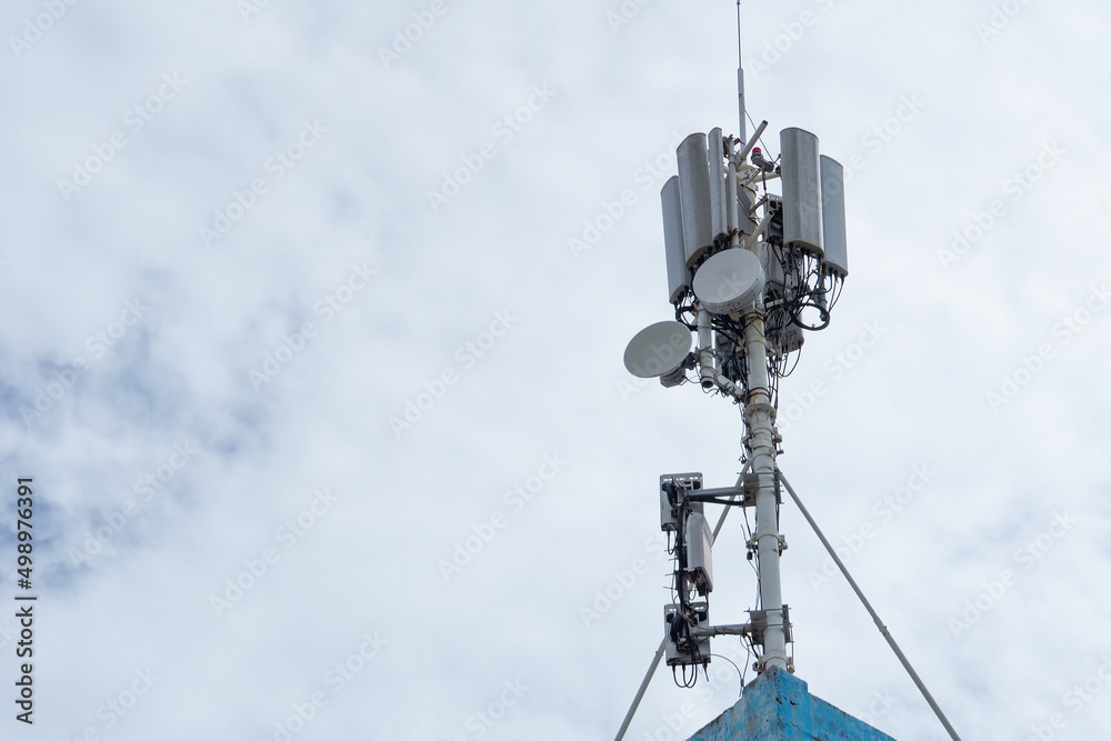 Modern tower 5 g on the background of a cloudy sky. Telecommunication antenna. Repeater. Communication tower.