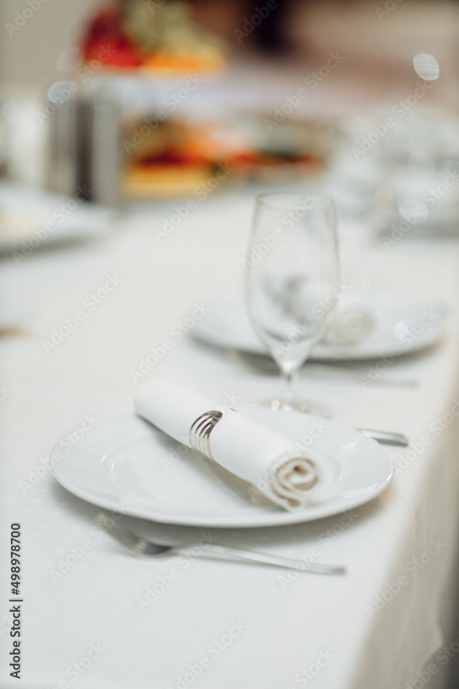 served table with glasses on a white tablecloth served table with glasses on a white tablecloth