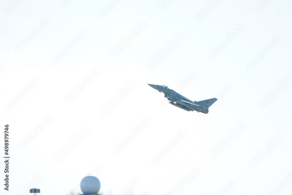 Eurofighter Typhoon military aircraft part of the Italian Air Force flying against blue sky. Military industry. Romania, 2022.