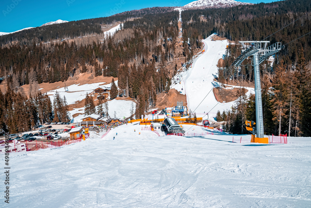 Naklejka premium Ski tracks on snow covered landscape against trees in forest at alps