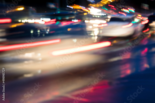 blurred view of city night lights and cars in motion