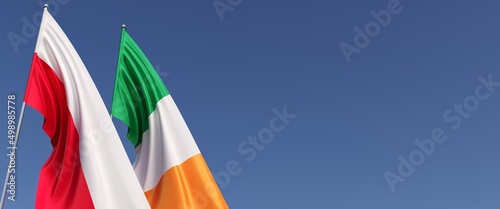 Flags of Poland and Ireland on the flagpole on side. Flags on a blue background. Place for text. Polish, Warsaw. Irish, Dublin. 3D illustration.