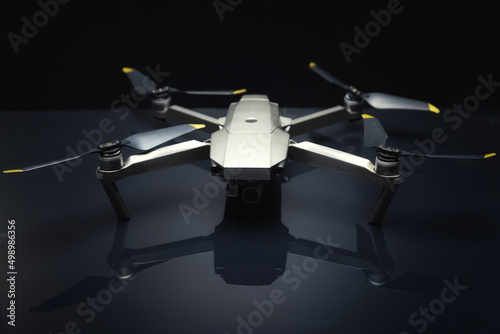 Grey drone against black background closeup photo