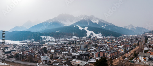 Panoramic view of beautiful town and snowcapped mountains against sky