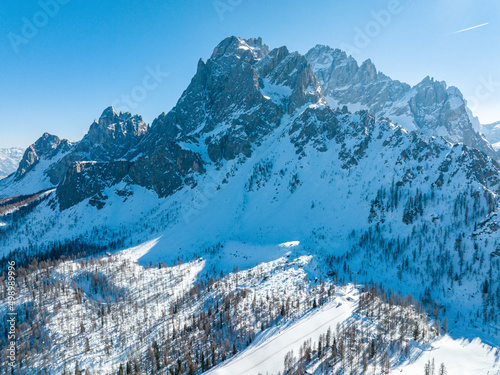 Scenic view of shadow on majestic snow covered mountain range against sky © ingusk