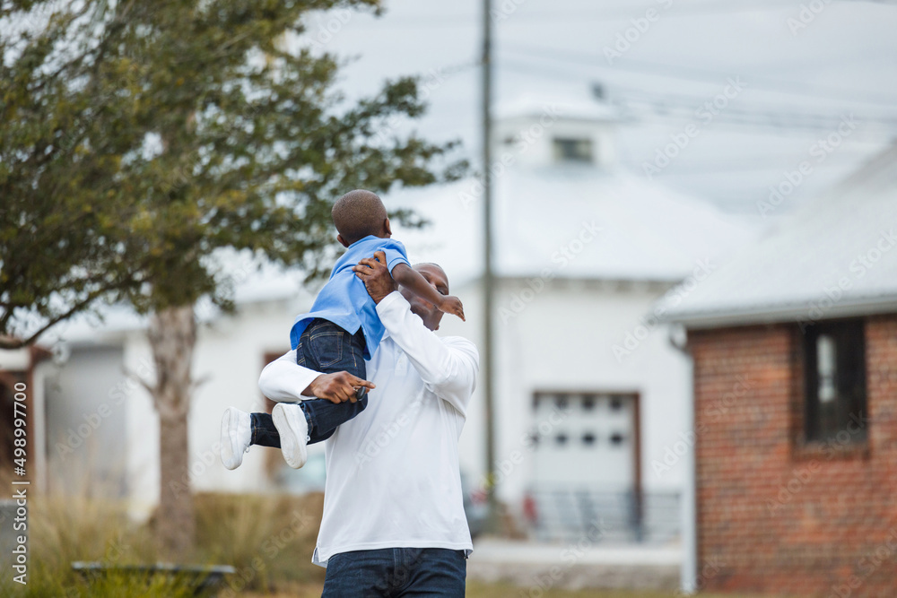 A prechool age little boy being picked up by his dad A prechool age little boy being picked up by his dad