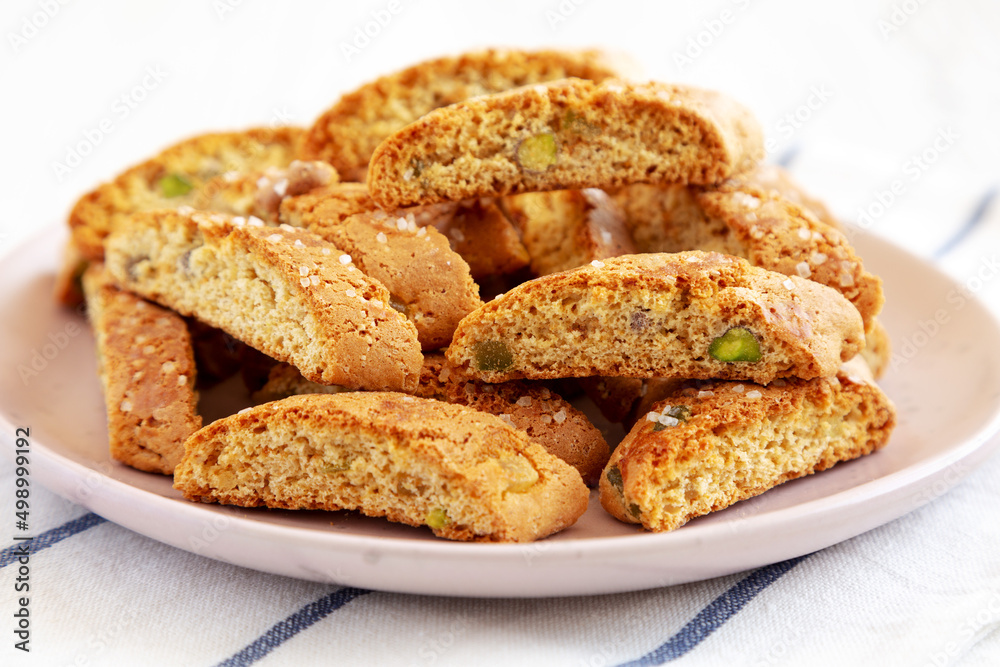 Homemade Italian Cantuccini with Pistachios and Citron on a Plate, side view. Crispy Pistachio and Citron Cookies.