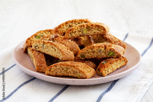 Homemade Italian Cantuccini with Pistachios and Citron on a Plate, side view. Crispy Pistachio and Citron Cookies. Close-up.