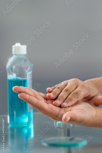 Woman using alcohol rub. Health