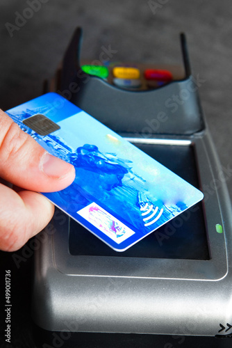 Woman paying with a contactless bank card. photo