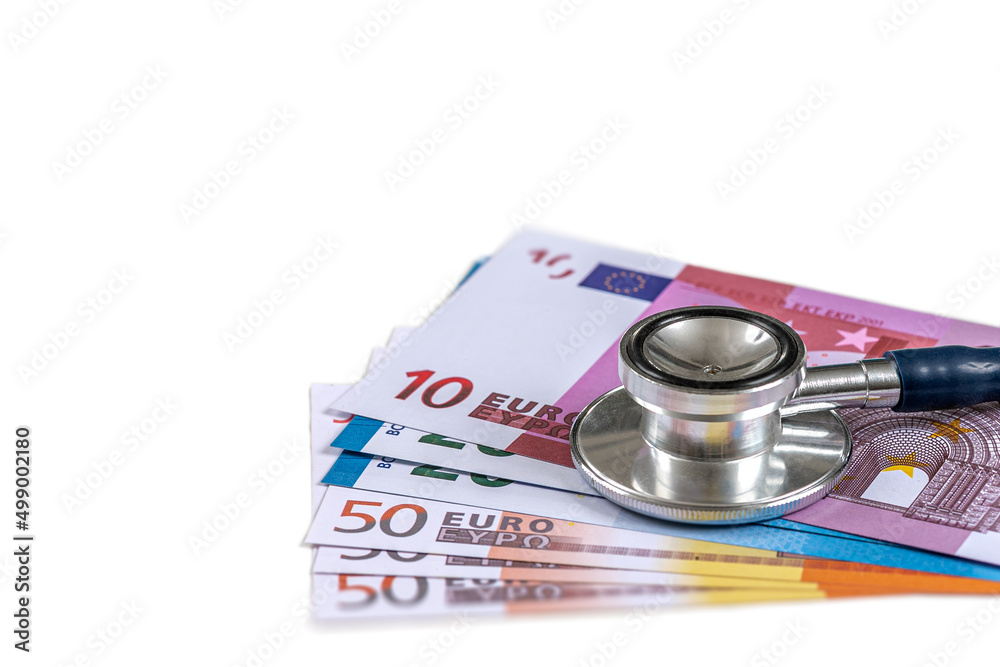 Stethoscope placed on wad of banknotes on white background showing.