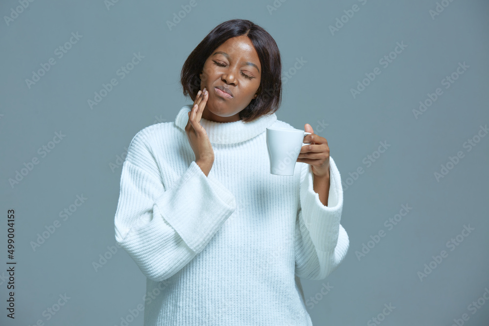 African american woman suffering toothache, sensitive enamel, holding hot drink cup. Dental clinic, medical insurance ad African american woman suffering toothache, sensitive enamel, holding hot drink cup. Dental clinic, medical insurance ad