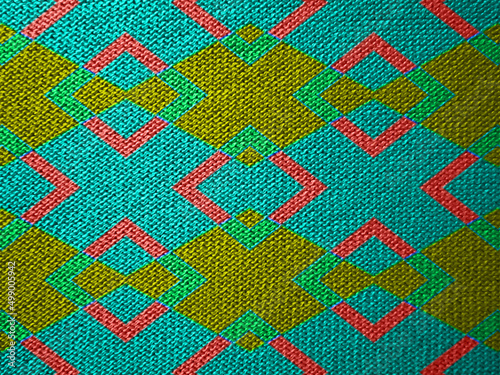 Pattern for knitwear, multicolor on a red background.
