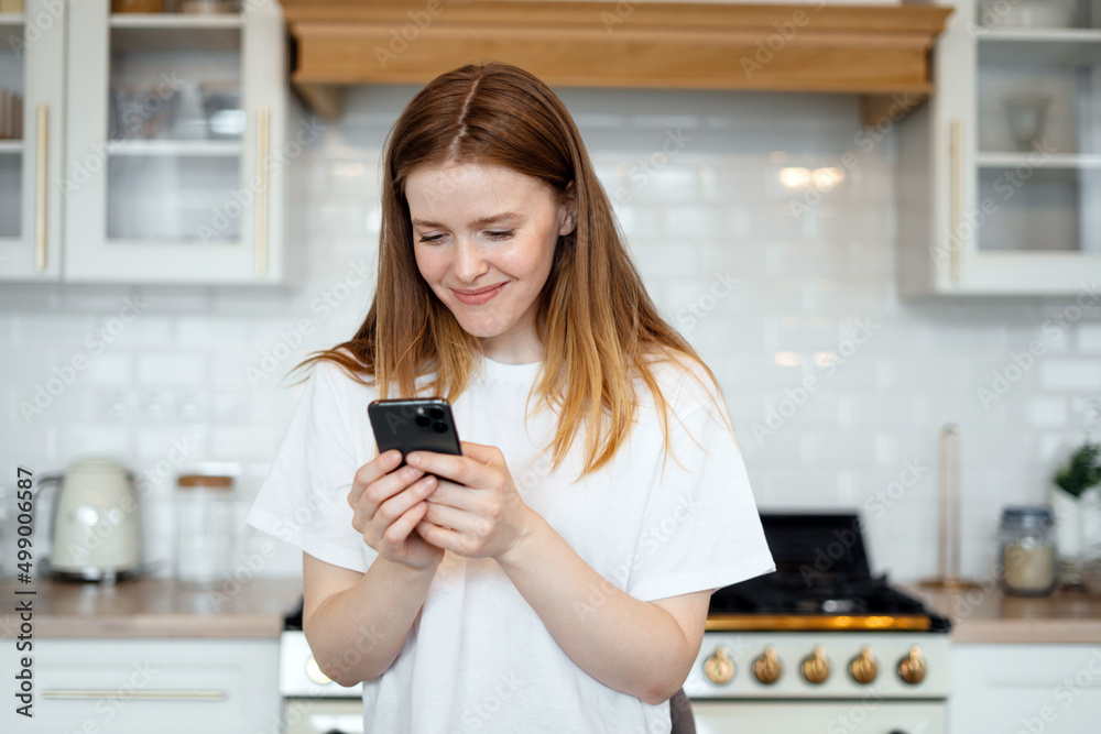 Uses a phone app and an internet site. Young female freelancer online learning education at home. Uses a phone app and an internet site. Young female freelancer online learning education at home.